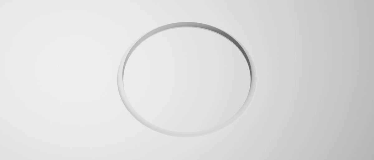 Frameless plaster-in circular ceiling diffuser for MVHR installed flush in a white plasterboard ceiling